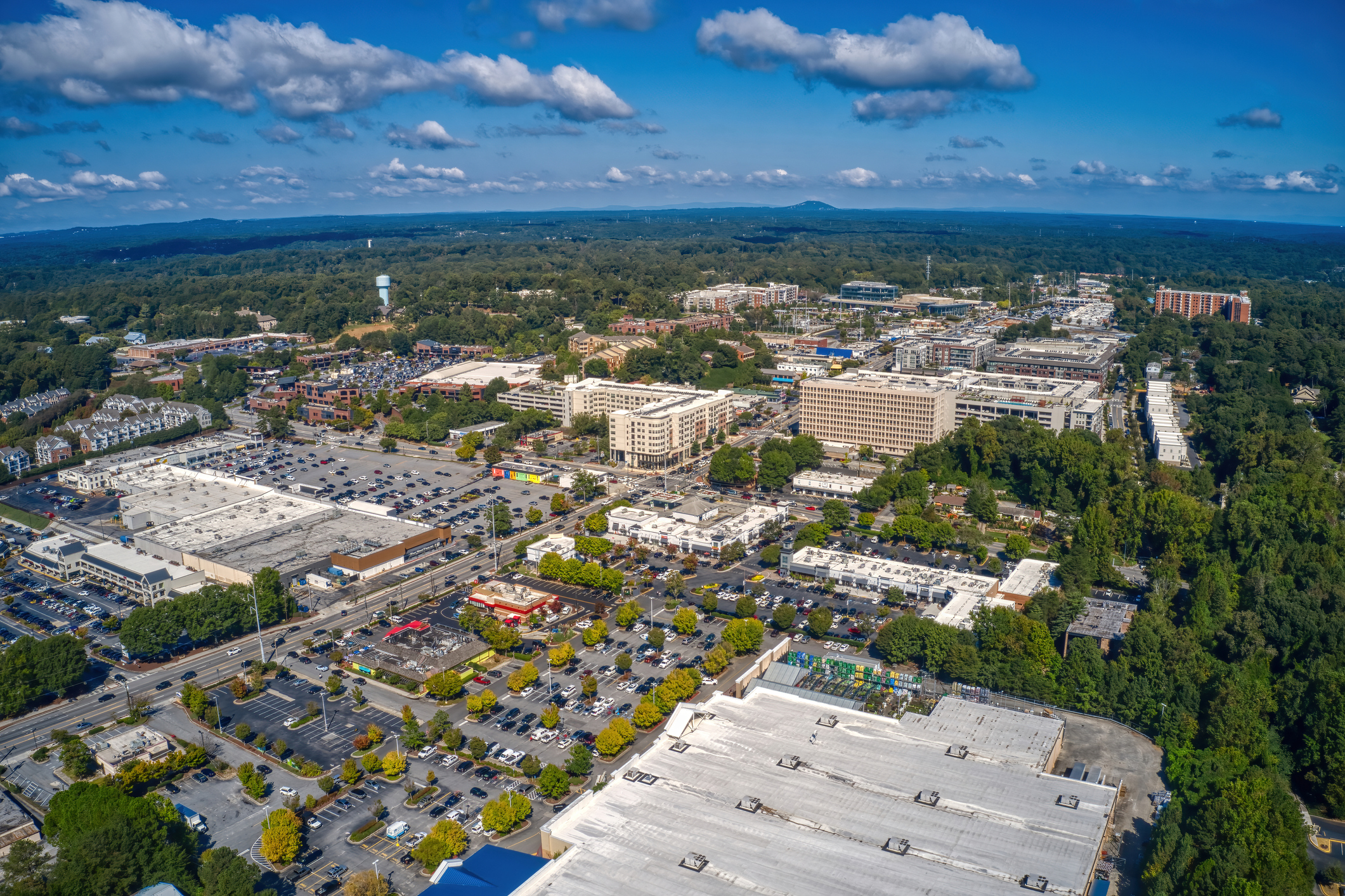 An aerial view of the Atlanta suburb of Sandy Springs under a blue sky with tiny clouds in Georgia